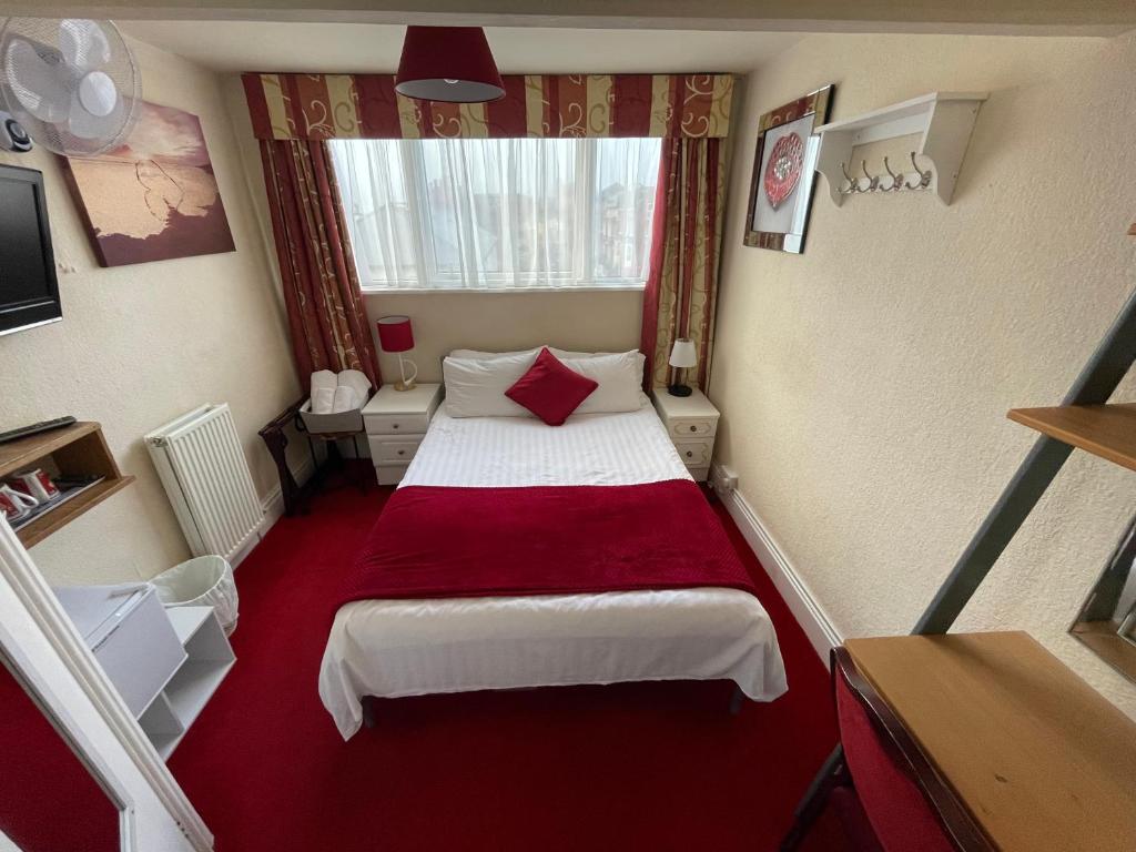 a small room with a bed and a window at Victoria House - Self Catering Quiet Guesthouse - Adult Singles and Couples Only in Blackpool