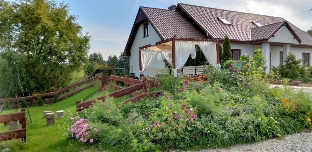 a house with a garden in front of it at Polne Zacisze in Lgiń