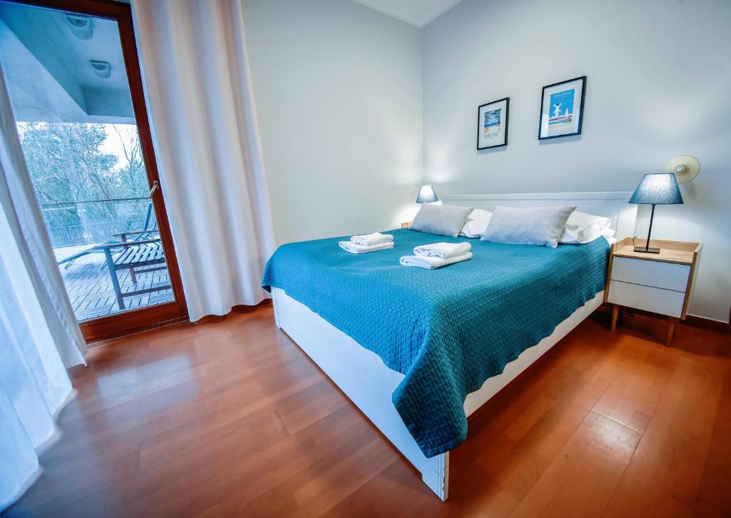 Posteľ alebo postele v izbe v ubytovaní Apartamenty na Wyspie - Baltic Park 3.0.7 - Apartament z 2 sypialniami i 80 m² tarasem