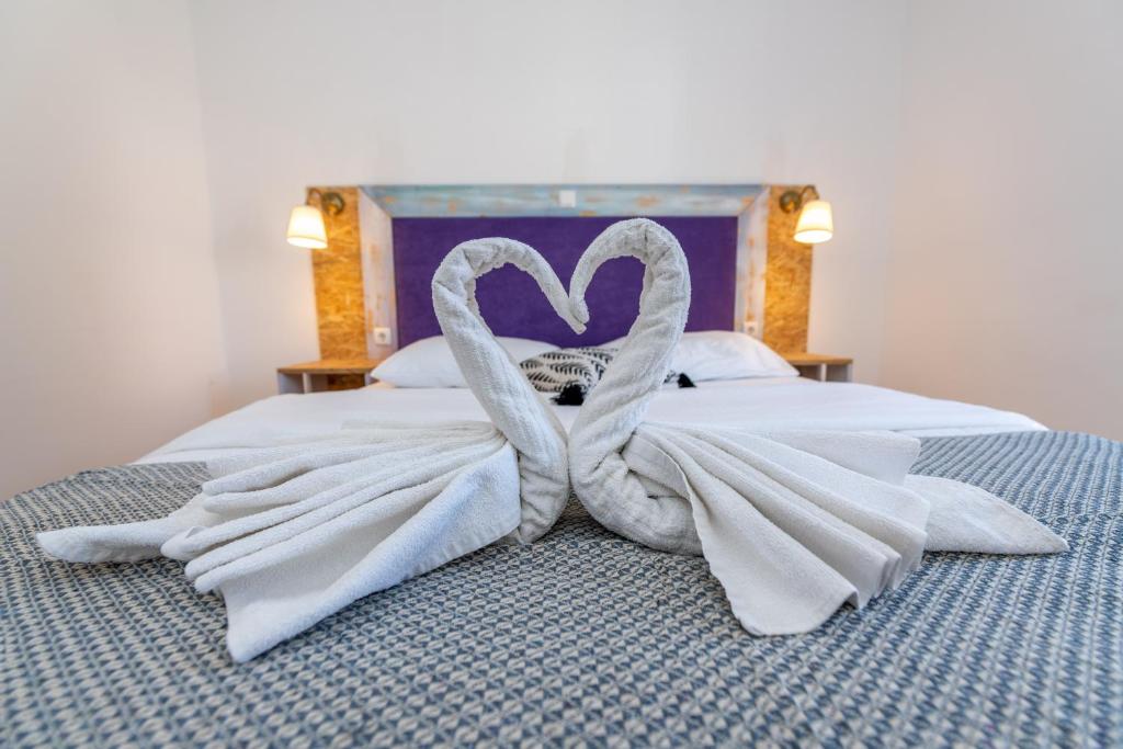 a bed with a swan made out of towels at Casa Olea in Pakoštane