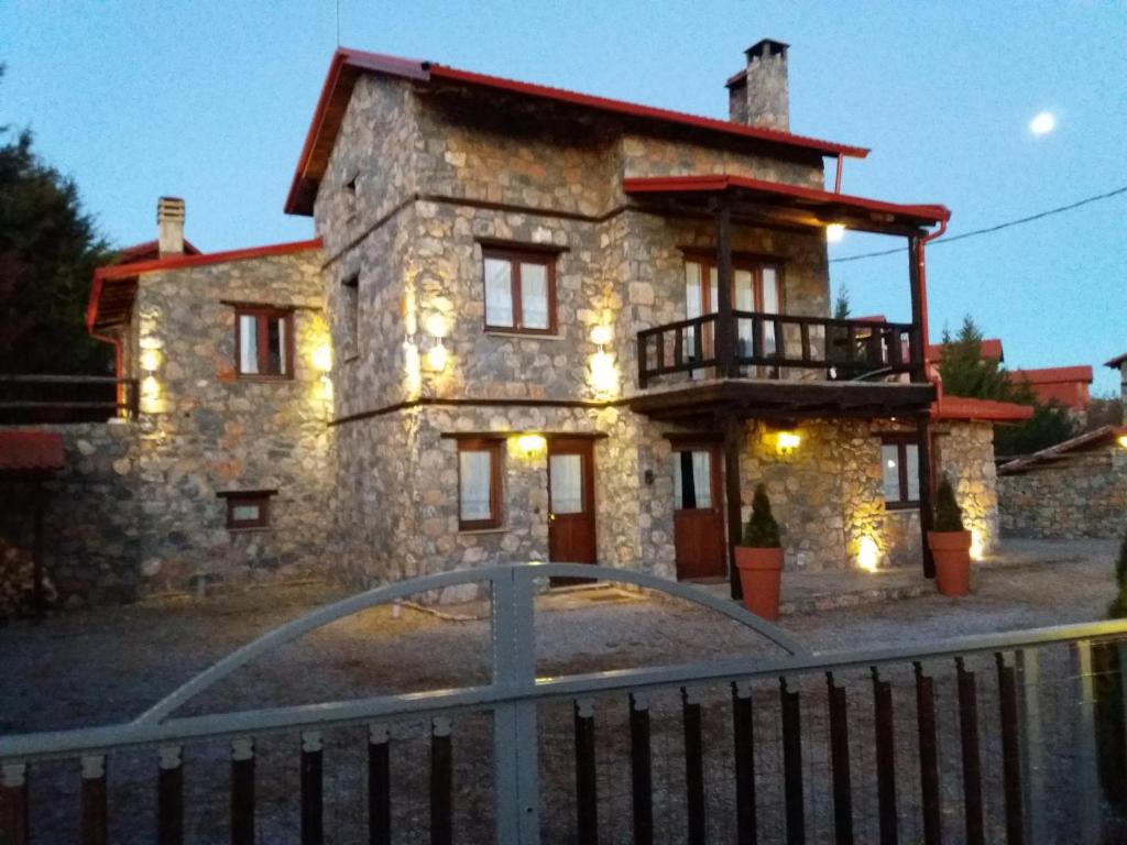 a stone house with a gate in front of it at Villa Monte Nord in Palaios Agios Athanasios