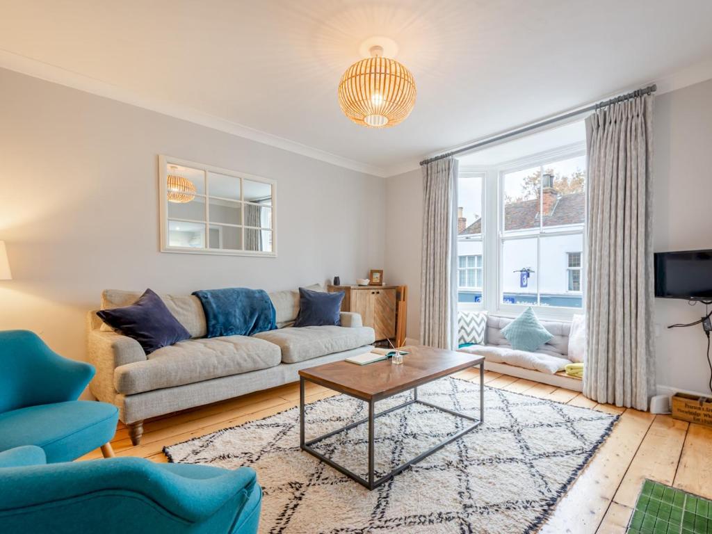 a living room with a couch and a table at Pass the Keys The Rafters - Impressive High Street Apartment in Whitstable