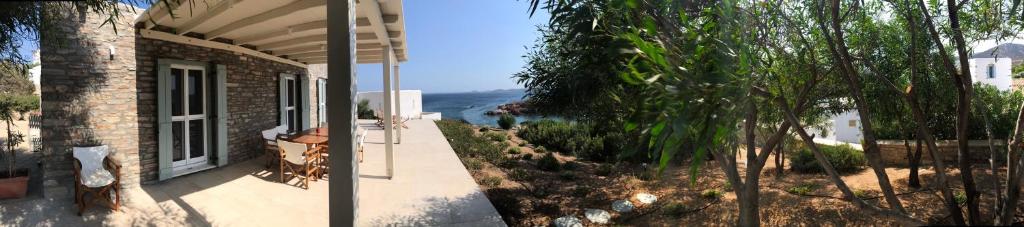 two pictures of a house with a view of the ocean at The Antiparos Stone House in Andiparos