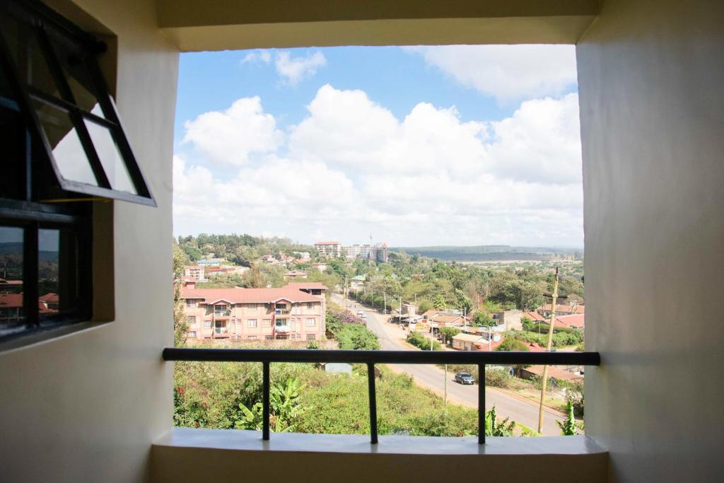 a window with a view of a city at Turbine Ngong Hotel in Ngong