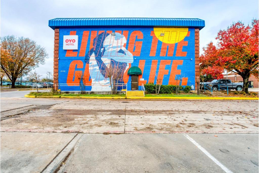 a building with a mural on the side of it at OYO Hotel Irving DFW Airport South in Irving