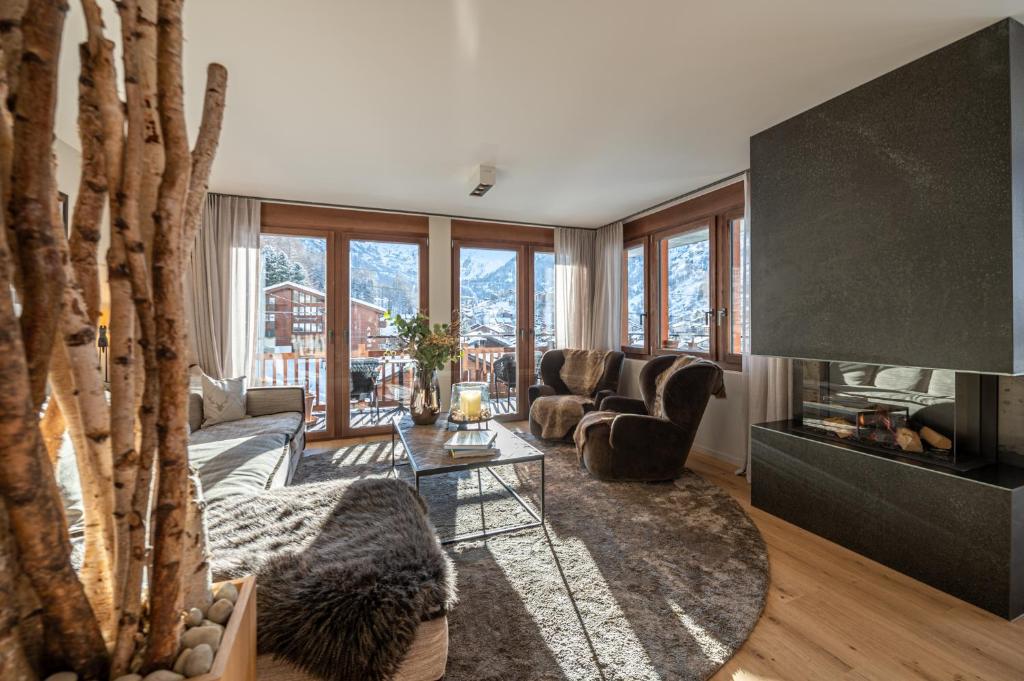 a living room with a couch and a table at Apartment Nabucco in Zermatt