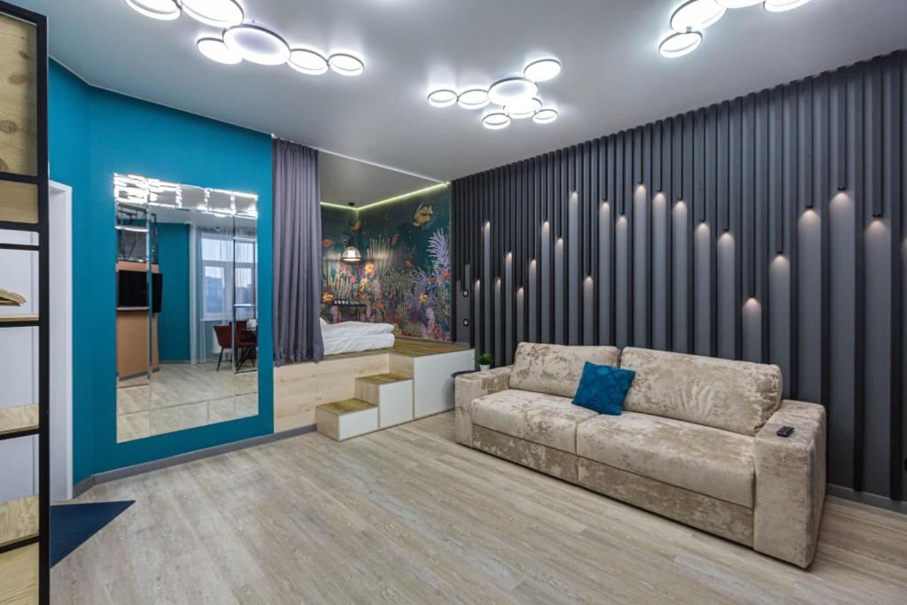 a living room with a couch and a bedroom at REHOME 24 in Tyumen