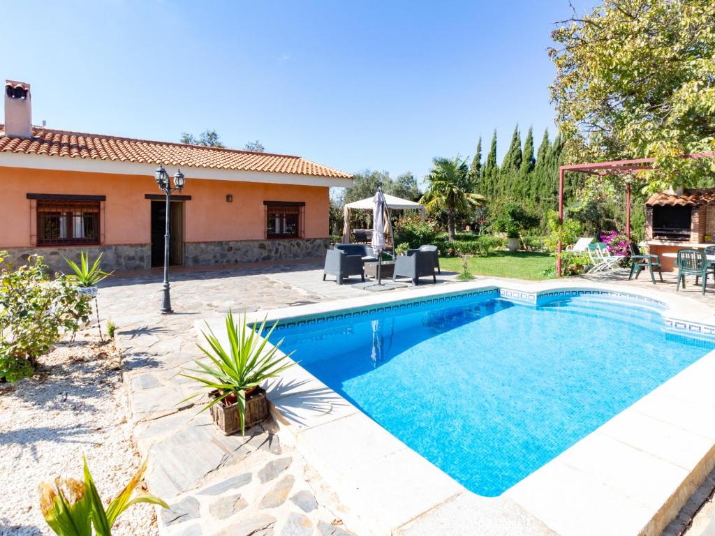 a swimming pool in the backyard of a house at Cortijo rincón del sur in Nigüelas