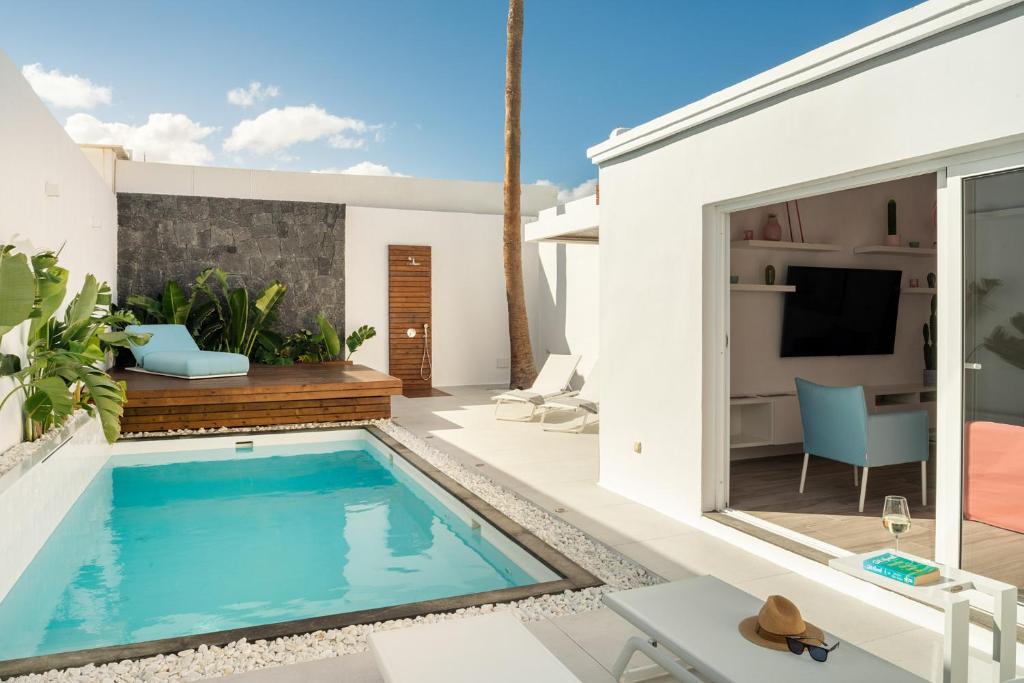 a swimming pool in the backyard of a house at Areca by AGM Resorts in Puerto del Carmen