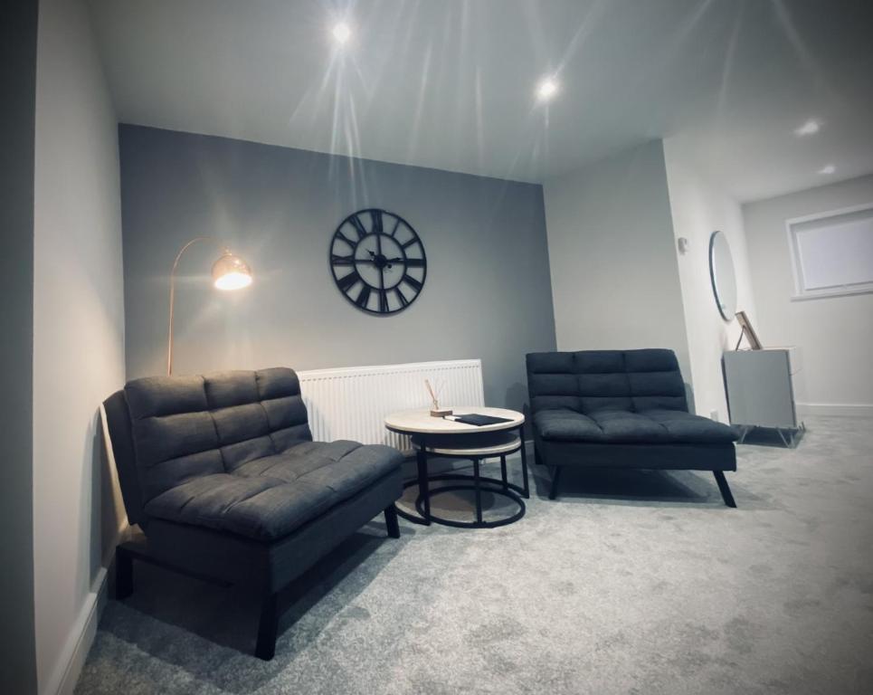 a waiting room with two chairs and a table at Seaview Luxury Apartments in Redcar