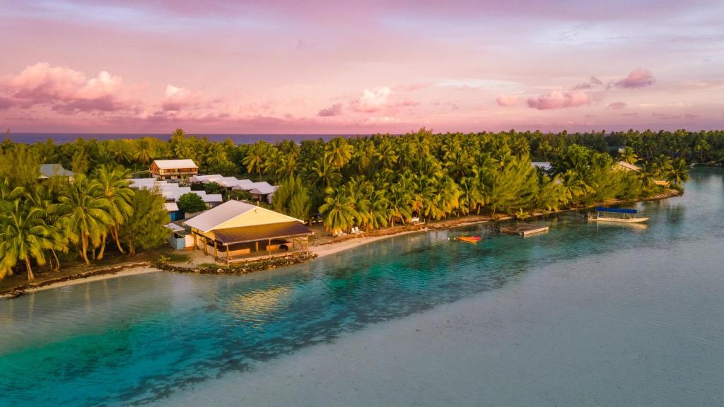 an aerial view of a resort on a beach with palm trees at Aitutaki Village in Arutanga