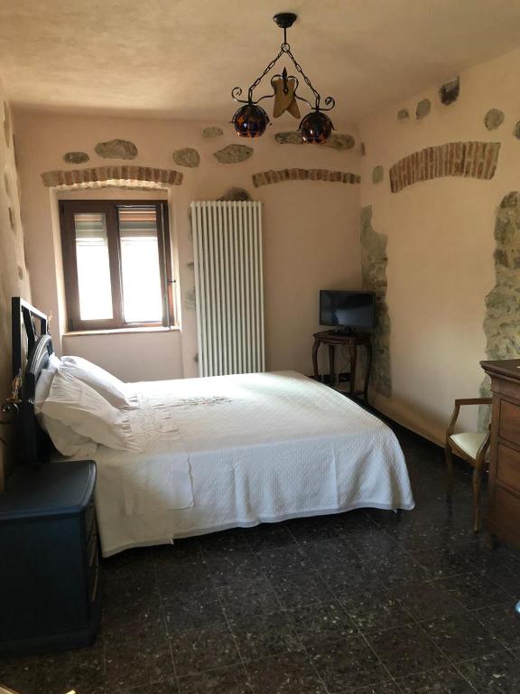 Posteľ alebo postele v izbe v ubytovaní LOCAZIONE TURISTICA IL BRICCHETTO