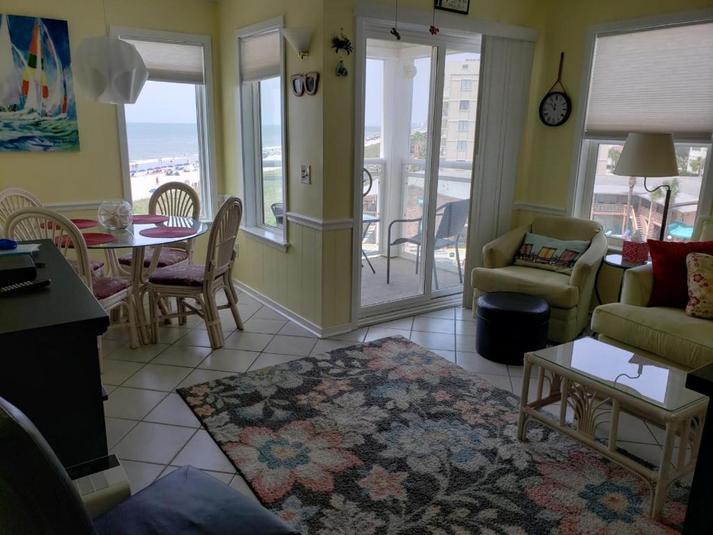 a living room with a couch and a table and chairs at A Place at the Beach 406 in Myrtle Beach