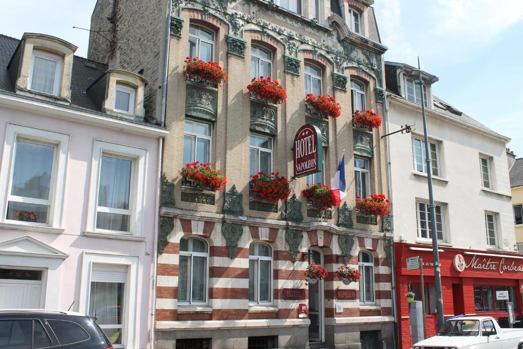 a building with flower boxes on the side of it at Hotel Napoléon in Cherbourg en Cotentin