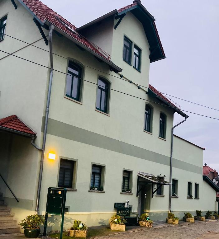 a large white building with a red roof at Ferienhaus im Gänseried in Erfurt