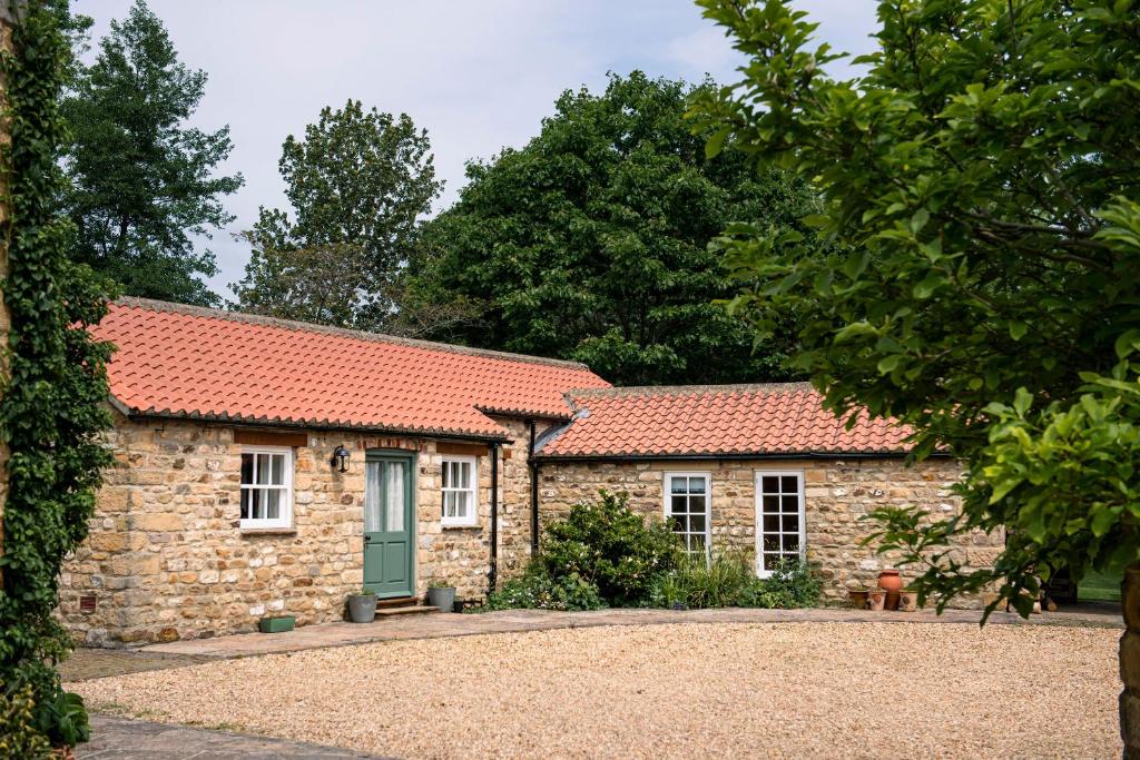 an old stone house with a red roof at Alwent Mill in Winston