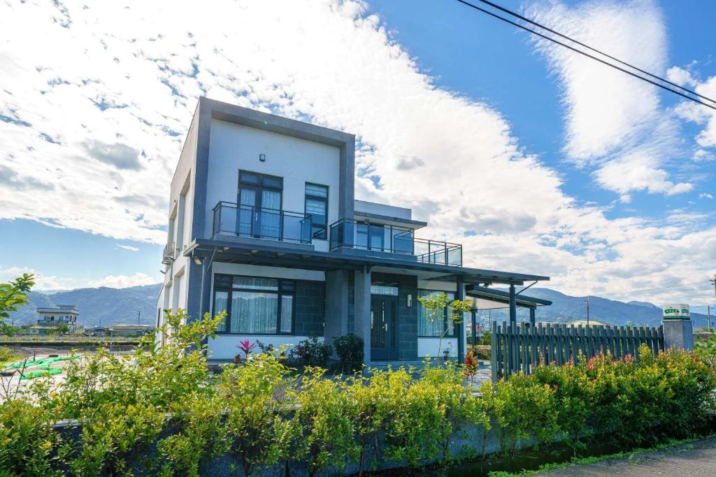 a house with a balcony on top of it at Dreams Come True B&B in Xingjian