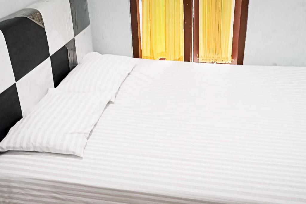 Postel nebo postele na pokoji v ubytování Homestay Dieng Persada Syariah Mitra RedDoorz