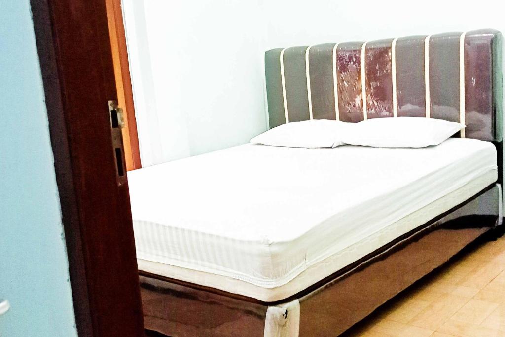 Postel nebo postele na pokoji v ubytování Homestay Dieng Persada Syariah Mitra RedDoorz