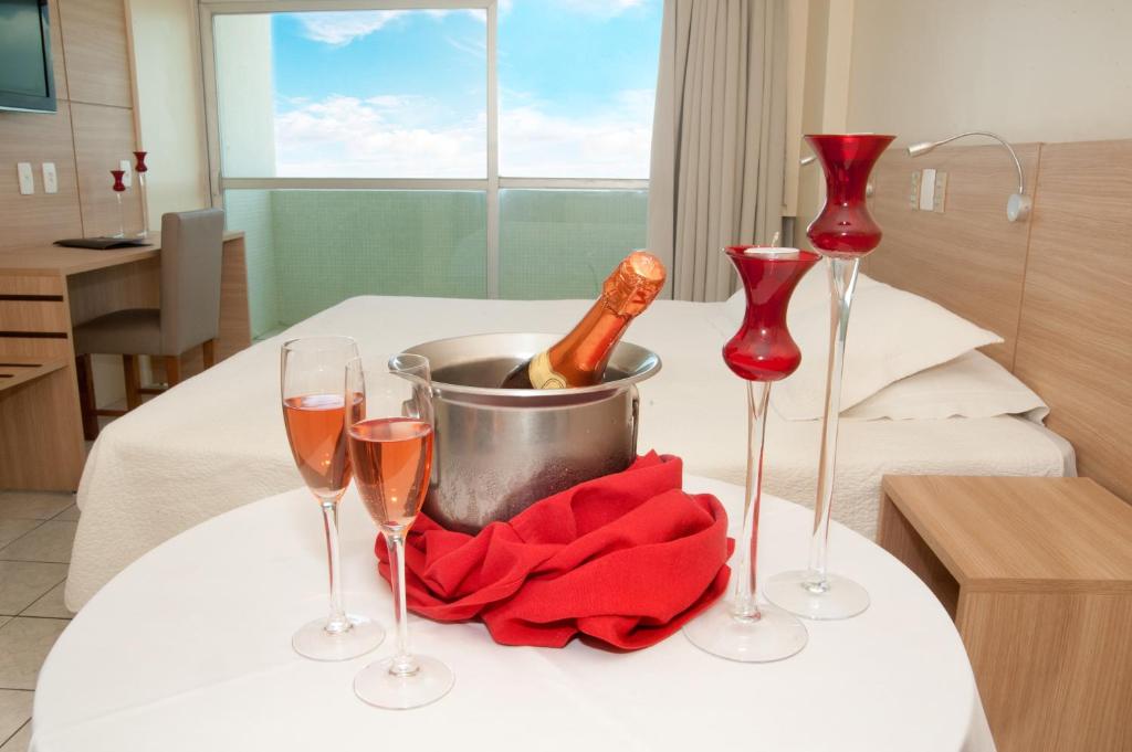 a table with wine glasses and a bucket of champagne at Hotel Jangadeiro in Recife