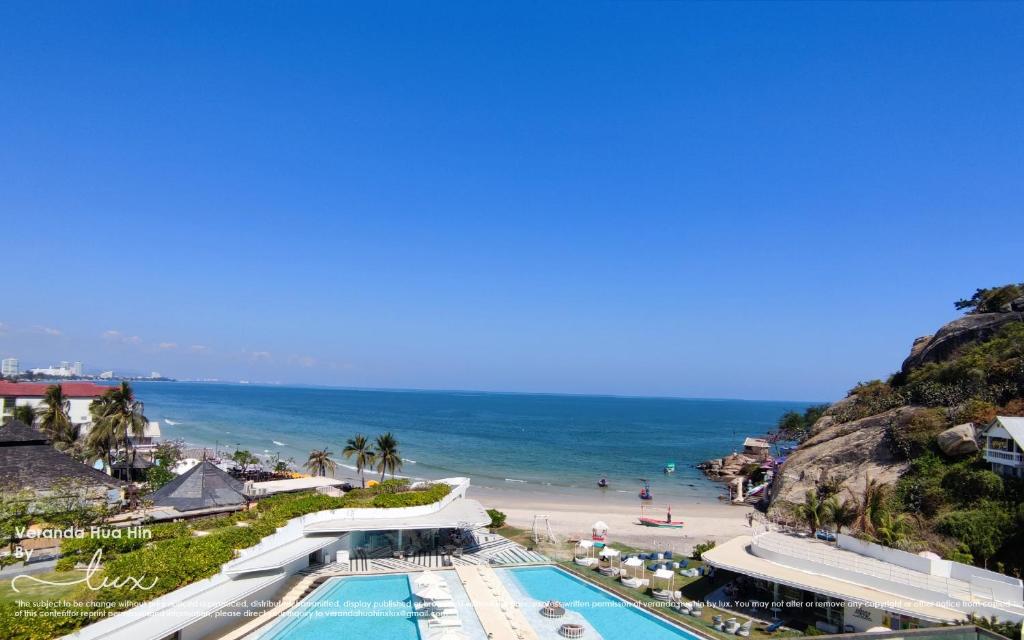a view of a beach with a swimming pool and the ocean at VERANDA HUAHIN BY LUX in Hua Hin