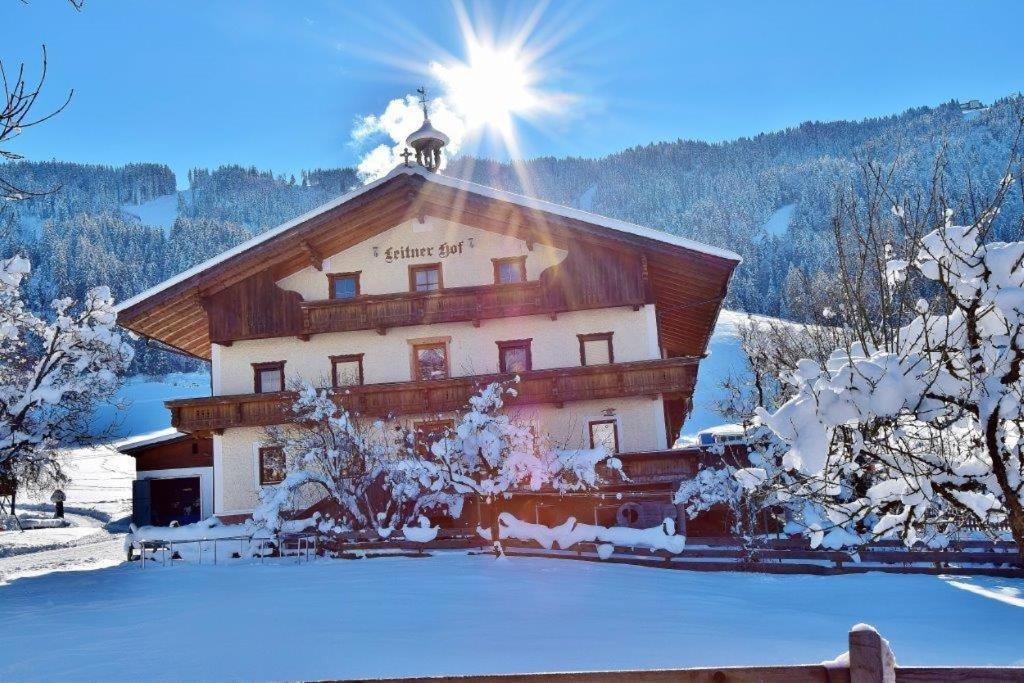 a large building with the sun on top of it at Leitnerhof in Niederau