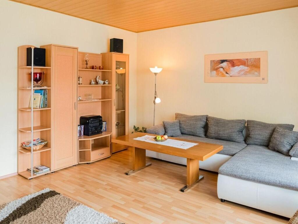 a living room with a couch and a table at Modernes Familienapartment in Medebach