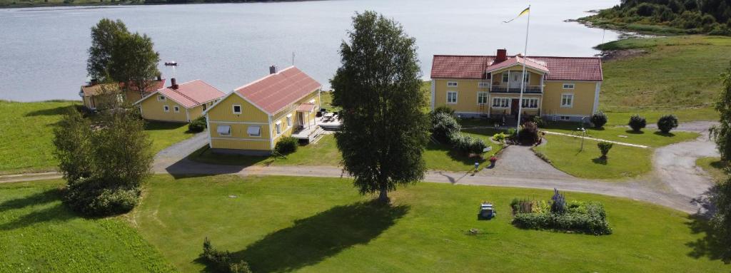 an aerial view of a house on a hill next to the water at Nivagården in Korpikylä