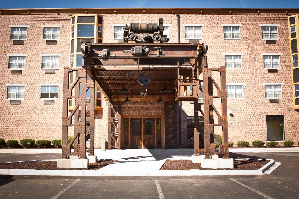 a building with a large structure in front of it at Ironworks Hotel in Beloit