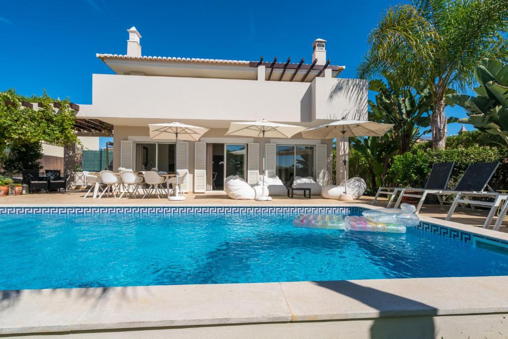 a villa with a swimming pool in front of a house at Casa Eleonora b&b in Lagos