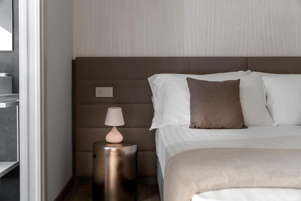 Postel nebo postele na pokoji v ubytování Civico25 Suite Hotel