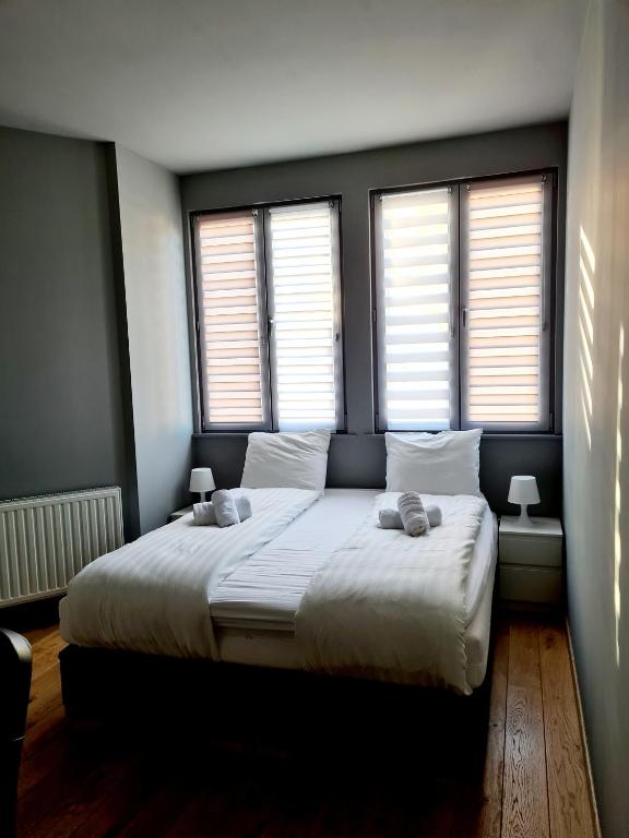 Letto o letti in una camera di HDC Nivelles Grand-Place