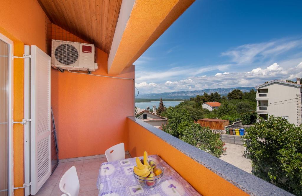 a balcony with a table with bananas on it at Apartments Stašić Katarina in Soline