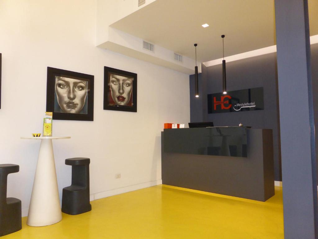 a room with two masks on the wall and a table at Correra 241 Lifestyle Hotel in Naples