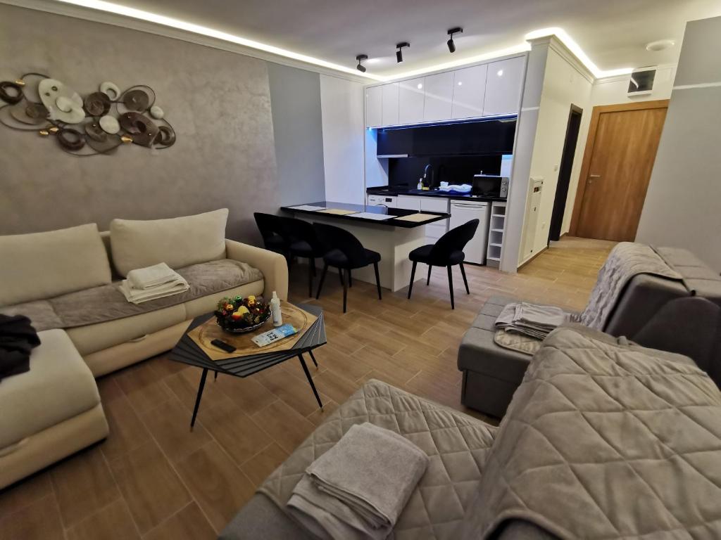 a living room with a couch and a table at Suncana planina apartman 103 in Kopaonik