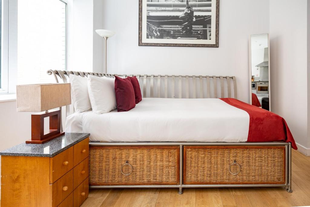 
a bedroom with a bed and a dresser at 196 Bishopsgate in London
