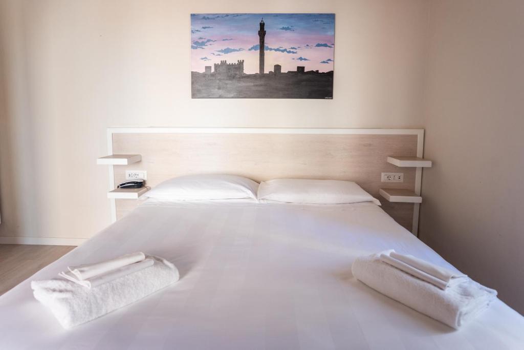 Łóżko lub łóżka w pokoju w obiekcie Albergo Centrale