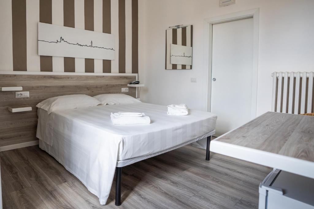 Łóżko lub łóżka w pokoju w obiekcie Albergo Centrale
