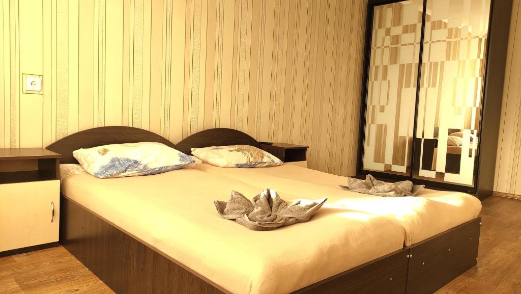 a bed in a room with two pillows on it at Проспект Незалежності 48 City Rooms in Bila Tserkva