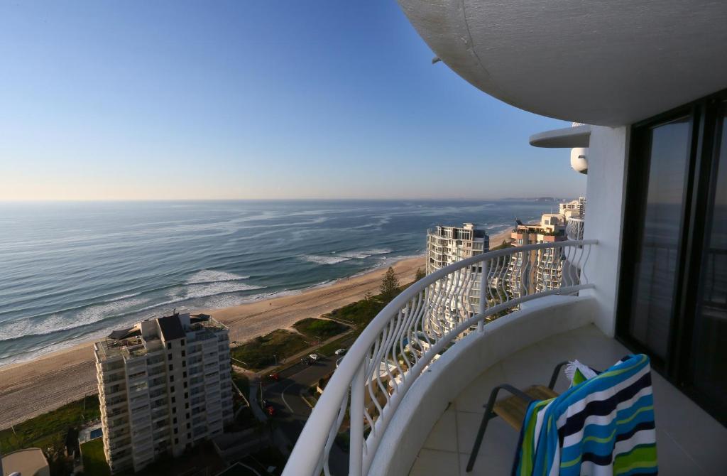 a balcony with a view of the beach and the ocean at Biarritz Apartments in Gold Coast