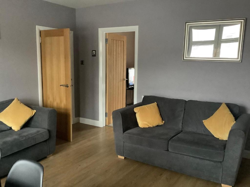 a living room with two couches and a window at 4 Stills Apartment in Rothes