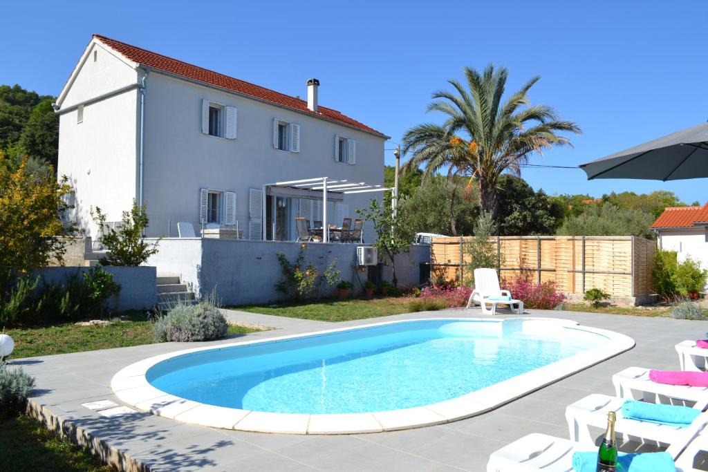 a swimming pool in the backyard of a house at holiday home on DUGI OTOK - OTOK in Brbinj