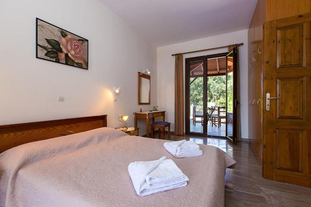 A bed or beds in a room at Aphrodite Villa