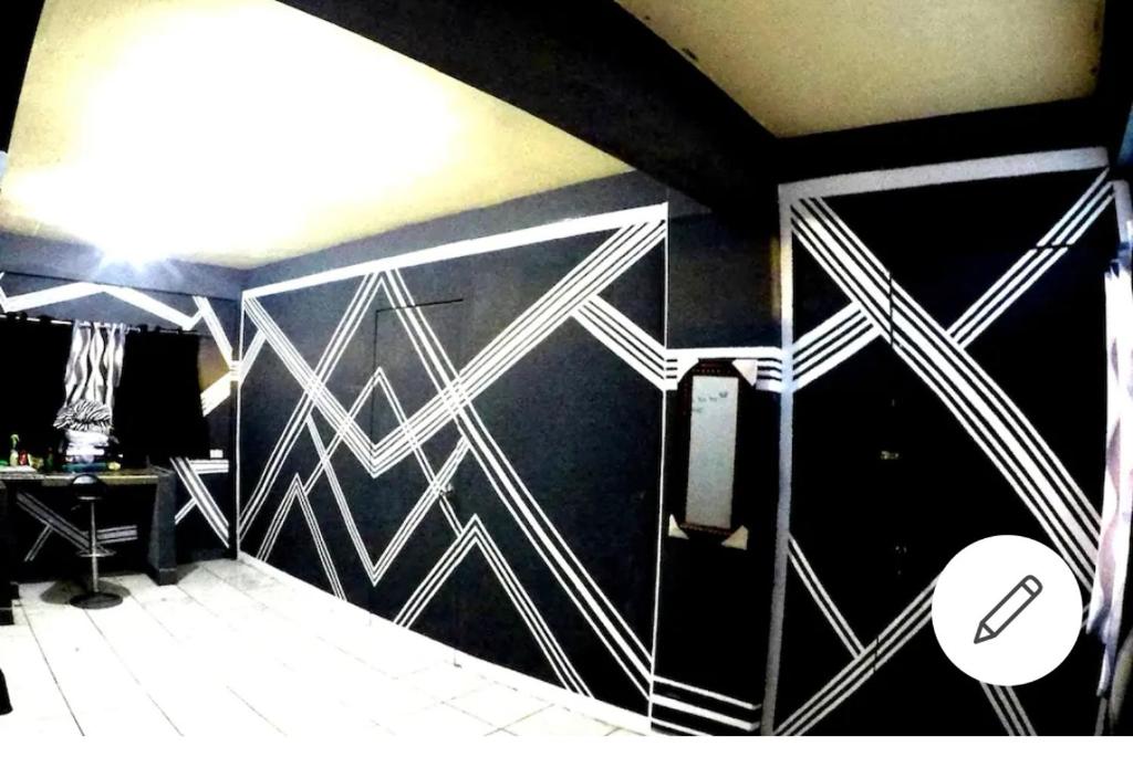 a bathroom with a black and white wall at Cabanatuan CIty PNY TRANSIENT INN 1 in Cabanatuan