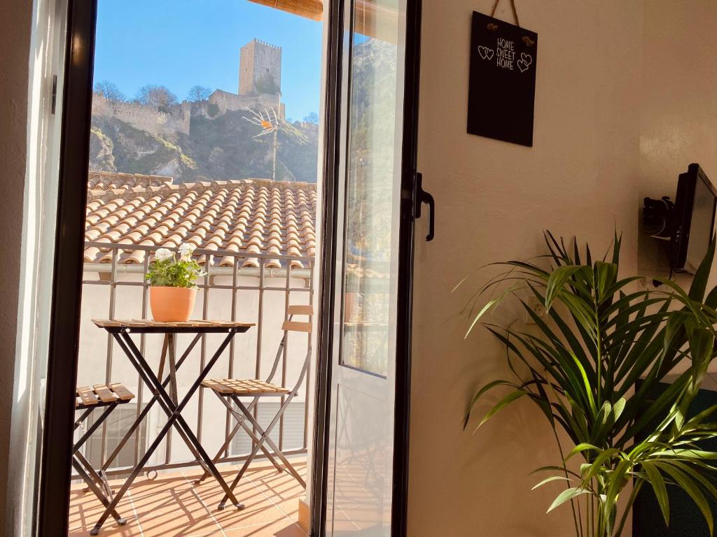 a door leading to a balcony with a table and a view at CASA CRIS OLDTOWN Cazorla in Cazorla