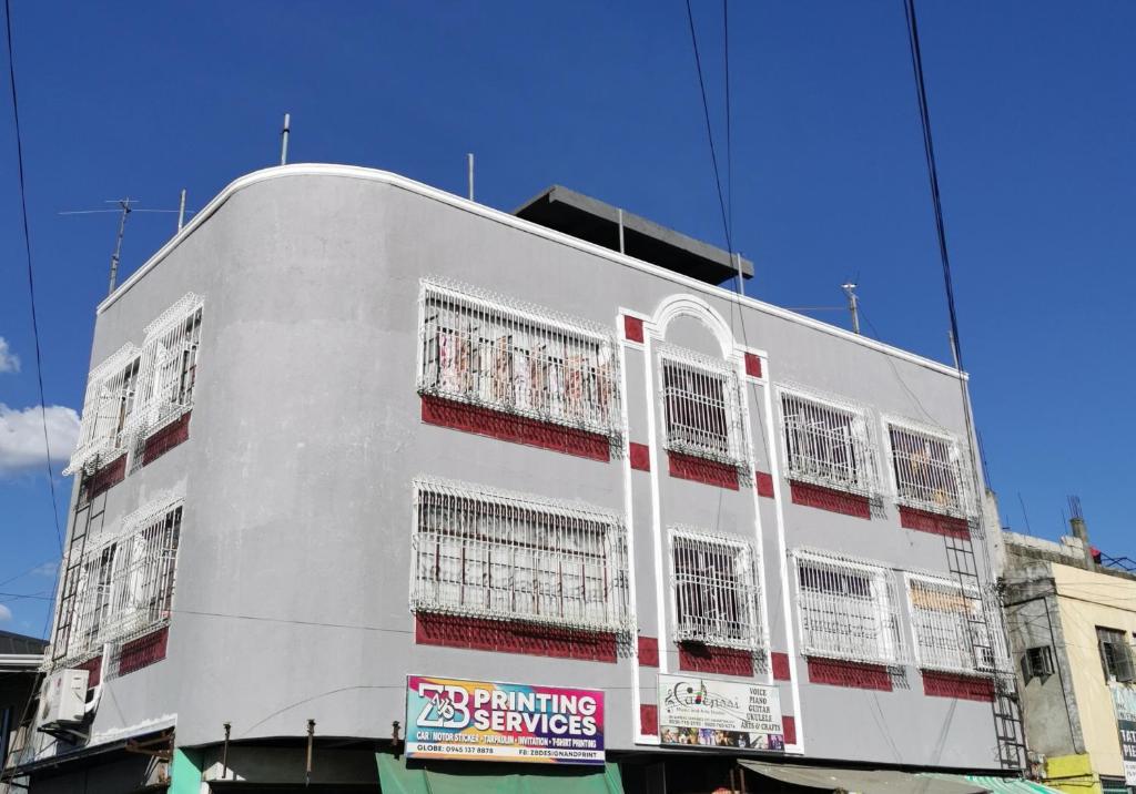a white building with a sign on the side of it at Cabanatuan City PNY TRANSIENT INN 3 in Cabanatuan