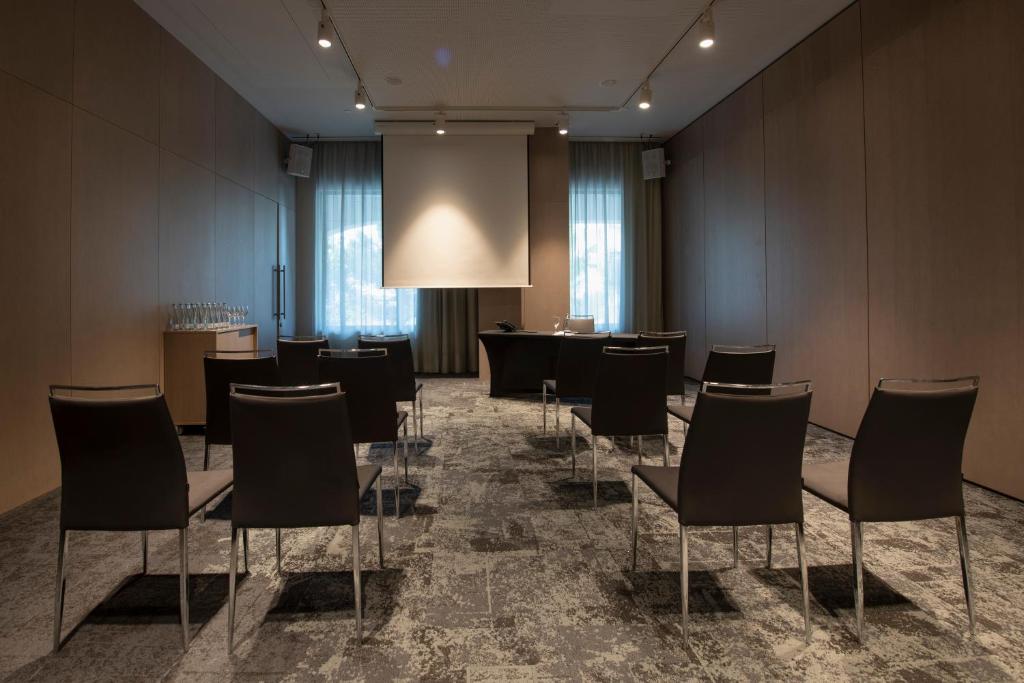 A smaller presentation room with forward-facing seating and a podium.