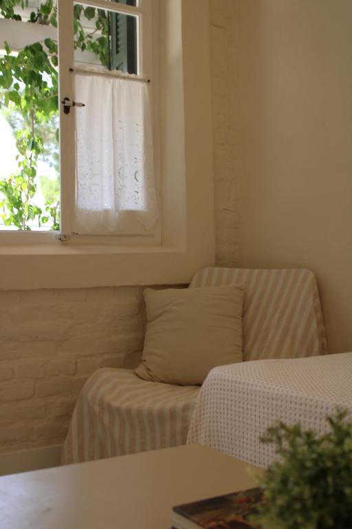 a living room with a couch and a window at Zefiros Traditional Hotel in Paleokastritsa