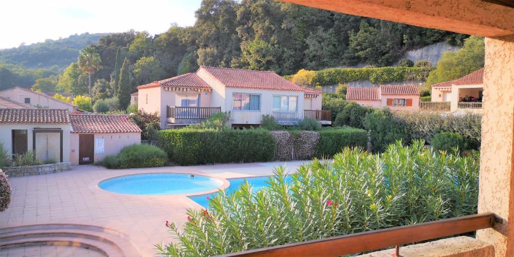 a house with a swimming pool in a yard at Résidence Cap Azur Appartement 237 in Villeneuve-Loubet