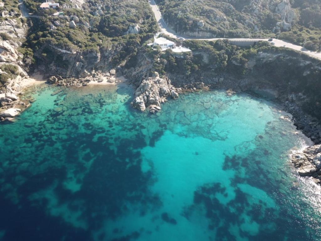 an aerial view of a beach with blue water at Villa Kuky in Santa Teresa Gallura